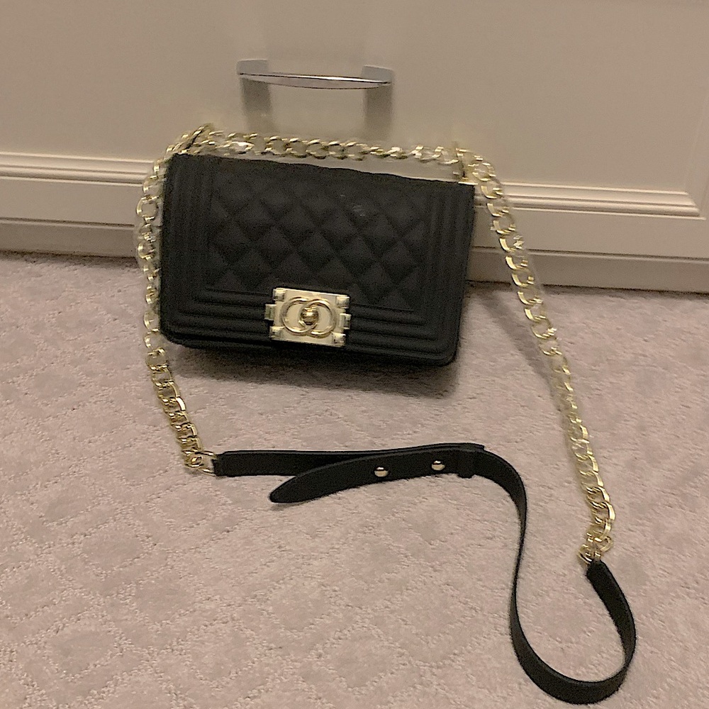 Black quilted bag with gold chain strap